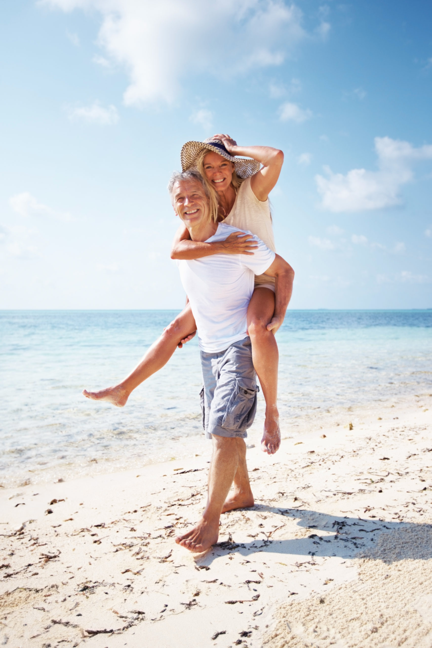 couple piggy backing on beach